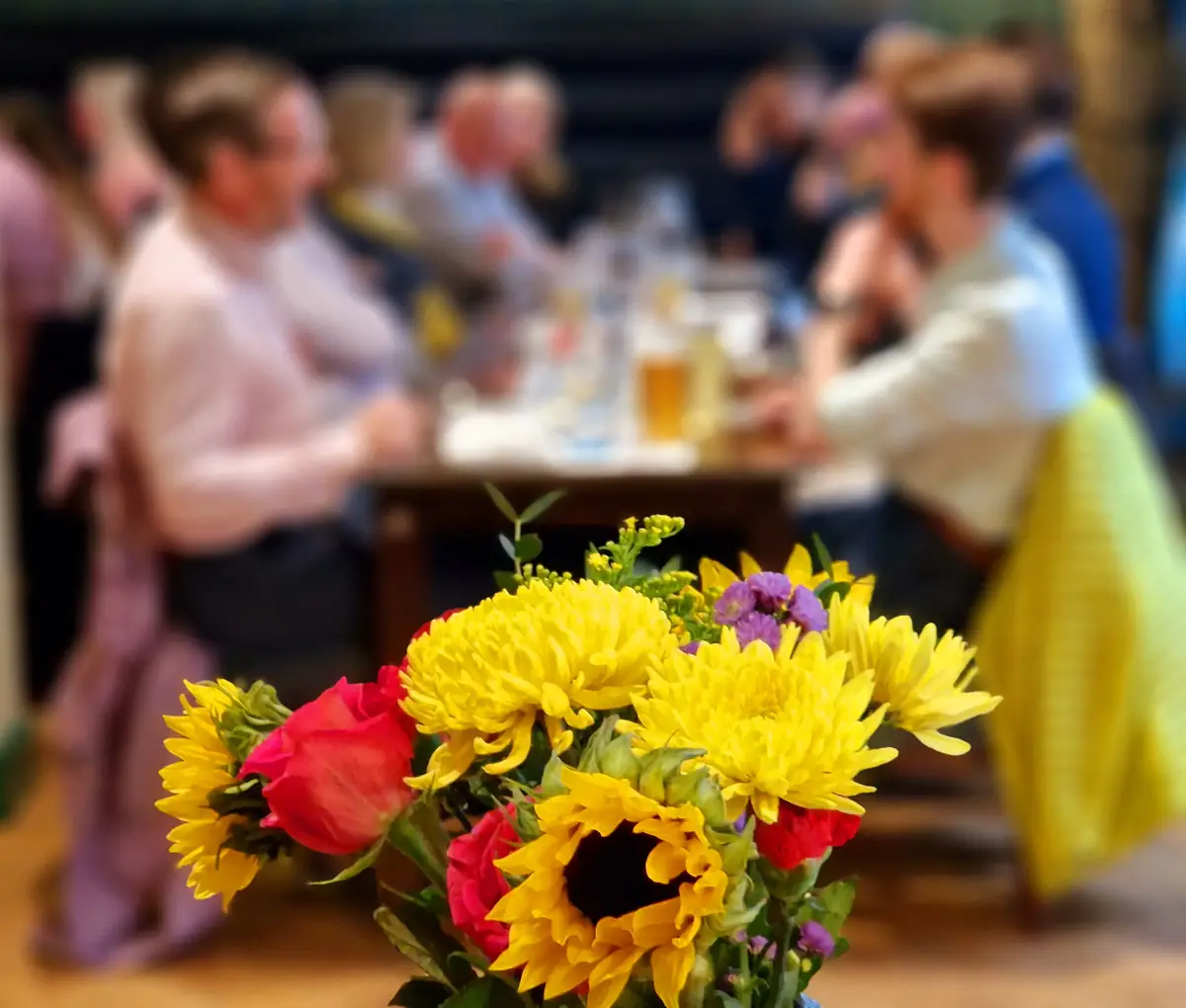 A long table set for a private party at Henlys, flowers in the foreground.