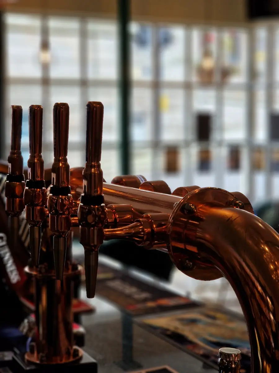 Copper beer taps on the bar at Henlys.